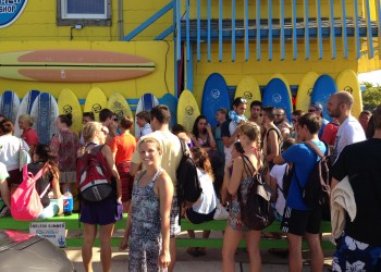 large group waiting outside endless summer surf shop